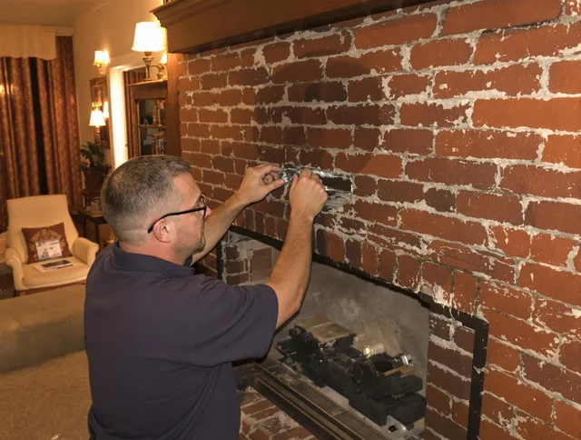 Streetsboro Chimney Sweep expert fixing a fireplace in Streetsboro, OH